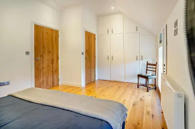 a bedroom with a bed and a chair in it at 3 Bed in Defynnog oc-p33133 in Devynock