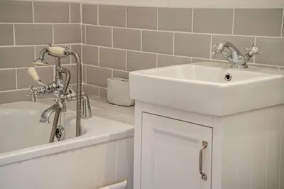 a white bathroom with a sink and a tub at 3 Bed in Defynnog oc-p33133 in Devynock