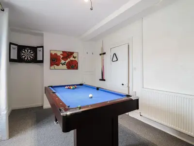 a pool table in a room with ahibition at Plas Yn Bonwm in Corwen