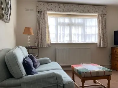 a living room with a couch and a window at Charming cottage in central Ludlow with parking in Ludlow