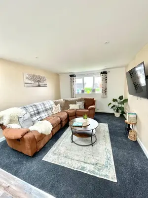 a living room with a couch and a table at Modern 1 Bed Apartment Sleeps 2 in Llanbadarn-fawr