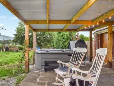 a patio with two chairs and a piano at The Cabin in Llangadog