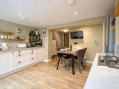 a kitchen and dining room with a table and chairs at Pass the Keys Charming 2 Bed Townhouse Short Walk To The River in Shrewsbury