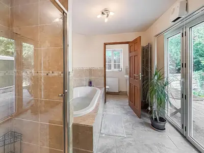 a bathroom with a bath tub and a shower at Brithdir in Welshpool