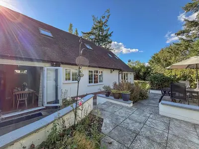 a white house with a patio and a table at Brithdir in Welshpool