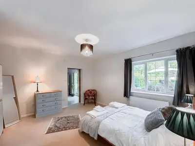 a white bedroom with a bed and a window at Brithdir in Welshpool