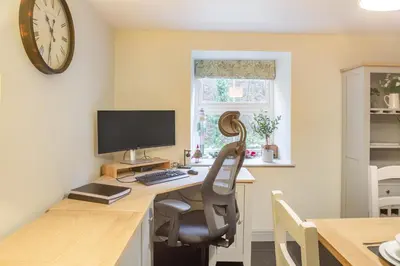 an office with a desk with a chair and a computer at Luxury Cottage near Dolgellau in Llanfachreth