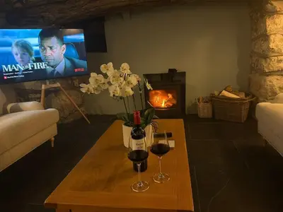 a living room with a table with two glasses of wine at Luxury Cottage near Dolgellau in Llanfachreth