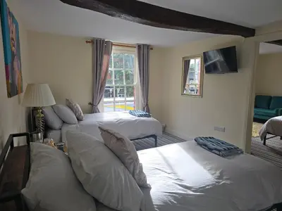 a hotel room with two beds and a window at Family room 2 - The Unicorn Hotel in Llanidloes