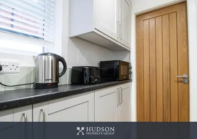 a kitchen counter with two toaster ovens on it at Central Oswestry 2 Bedroom House in Oswestry