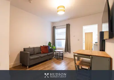 a living room with a couch and a table at Central Oswestry 2 Bedroom House in Oswestry