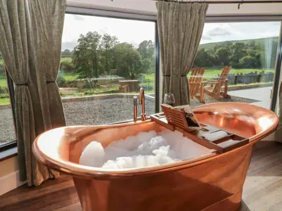 a bath tub filled with snow in front of a window at Ty Crwn - The Roundhouse in Lampeter
