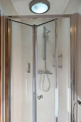 a shower with a glass door in a bathroom at The Castle Inn in Wigmore