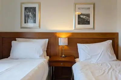 two beds sitting next to each other in a bedroom at The Castle Inn in Wigmore
