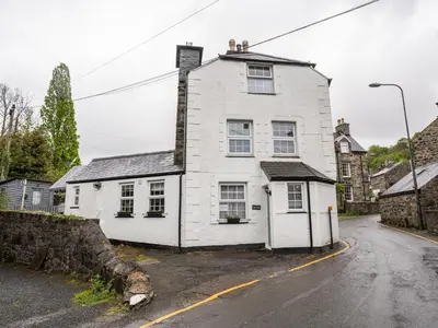 a white house on the side of a street at Garn View in Dolgellau
