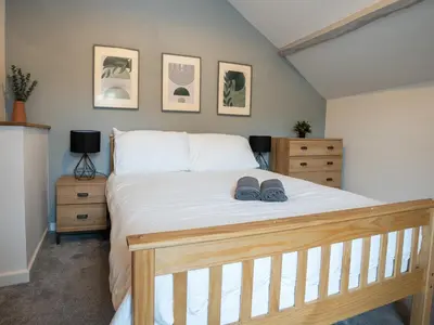 a bedroom with a bed with two shoes on it at Garn View in Dolgellau