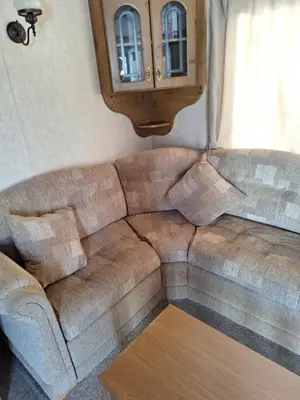 a brown couch in a living room with a table at TF1 Static in Aberystwyth