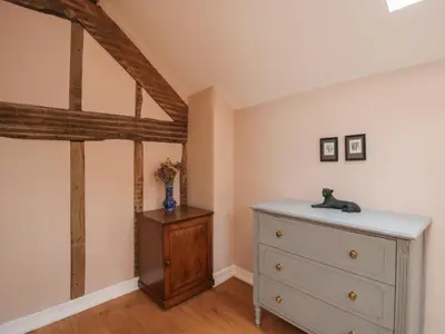 a bedroom with a dresser in a attic at Malt House in Bishops Castle