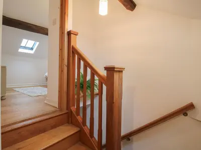 a staircase in a home with wooden floors at Malt House in Bishops Castle