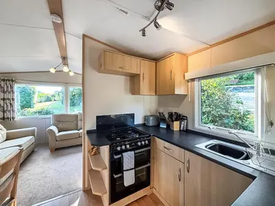 a small kitchen with a stove and a sink at Hafren View in Machynlleth