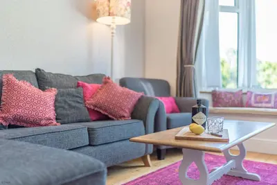 a living room with a couch and a coffee table at Artro in Llanbedr