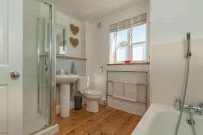a bathroom with a toilet and a sink and a shower at Artro in Llanbedr