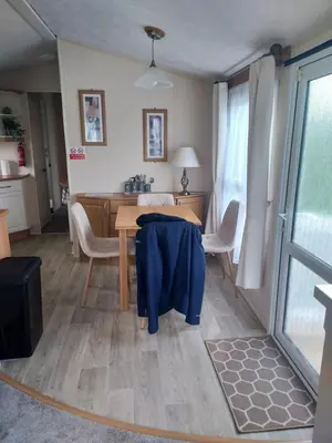 a dining room with a table with a blue jacket on it at Rosie's Rest in Aberaeron