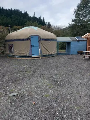a large tent with a blue door in a yard at Hillside Retreats in Machynlleth