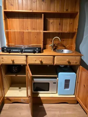 a kitchen with a microwave and a sink at The Rheidol Shepherds Hut in Aberystwyth