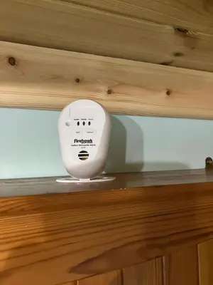 a white appliance sitting on top of a wooden cabinet at The Rheidol Shepherds Hut in Aberystwyth