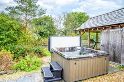 an outdoor hot tub with a refrigerator on top of it at West Barn - 2 Bedroom Cottage - Llandeilo in Llandeilo