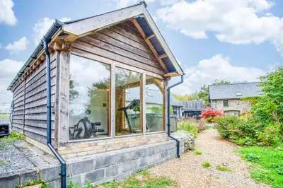 a house with a large window on the side of it at West Barn - 2 Bedroom Cottage - Llandeilo in Llandeilo