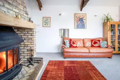 a living room with a couch and a fireplace at West Barn - 2 Bedroom Cottage - Llandeilo in Llandeilo