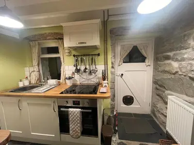 a kitchen with a sink and a counter top at Patchwork cottage - Grade 2 listed cottage in Snowdonia in Maentwrog