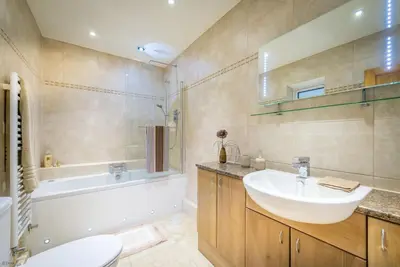 a bathroom with a sink and a tub and a toilet at Mehefin in Harlech