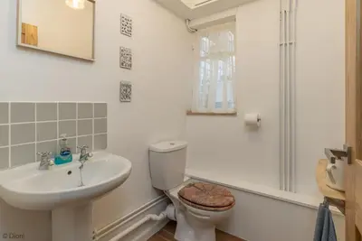 a bathroom with a toilet and a sink at Bryn-Yr-Aur in Llanfair