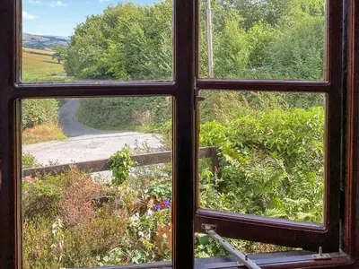 an open window with a view of a road at Lower Rheol in Erwood