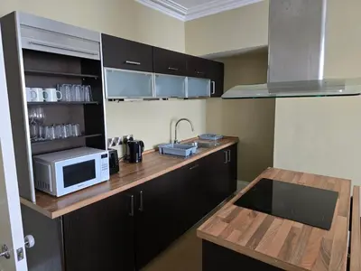 a kitchen with a wooden counter top with a microwave at Seaview Apartment in Aberystwyth