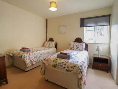 a bedroom with two beds and a window at Upper Pandy Farm in Welshpool