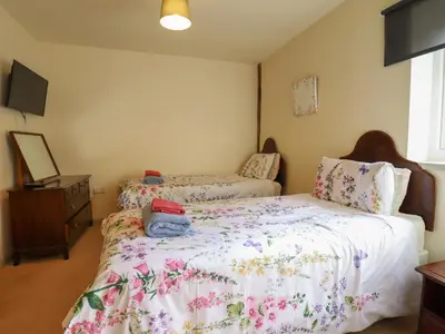 a bedroom with a bed and a dresser at Upper Pandy Farm in Welshpool