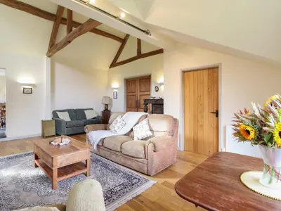 a living room with a couch and a table at Upper Pandy Farm in Welshpool