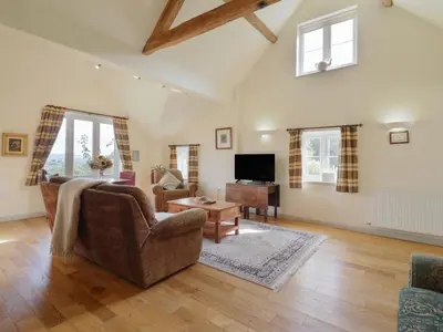 a living room with a couch and a table at Upper Pandy Farm in Welshpool