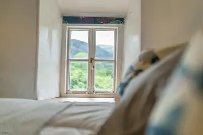 a window in a room with a bed at Pwll-Y-March in Llanbedr