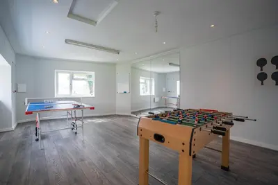 a room with a foosball table and a table at Rheithordy in Blaenau-Ffestiniog