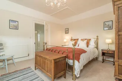 a bedroom with a bed and a table and a desk at Rheithordy in Blaenau-Ffestiniog