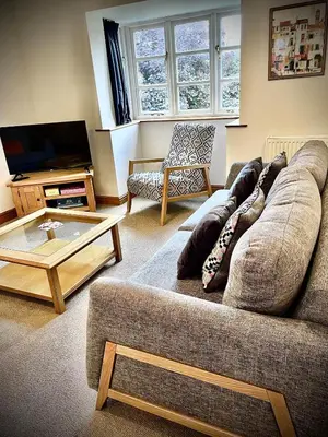 a living room with a couch and a coffee table at Vicarage Court detached bungalow in Oswestry