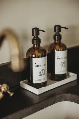 two bottles of soap sitting on a bathroom counter at Ty Mawr, The Old School Holiday Homes - Pet Friendly in Llanwrtyd Wells