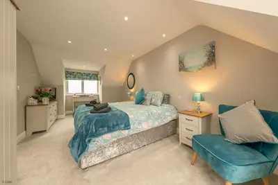 a bedroom with a bed and a chair at Tan-Y-Foel in Dyffryn