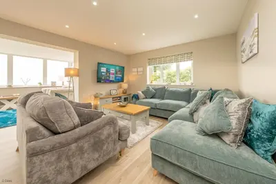 a living room with two couches and a table at Tan-Y-Foel in Dyffryn