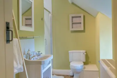 a bathroom with a white toilet and a sink at Ceseilgwm in Corwen
